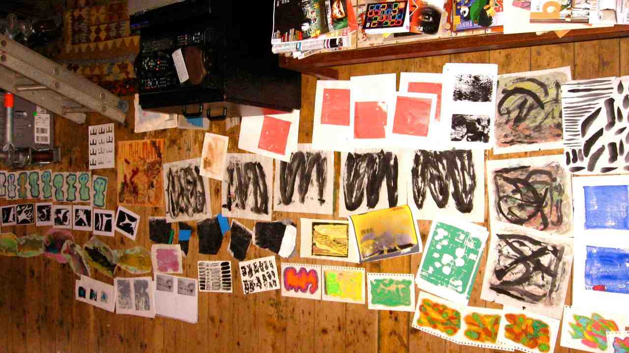 A spread of artwork on the studio floor.